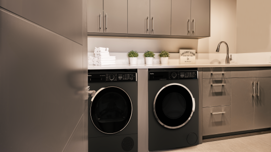 Szara kuchnia, pralka i suszarka są ustawione obok siebie.