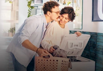 Kobieta i mężczyzna przy pralce ładowanej od góry